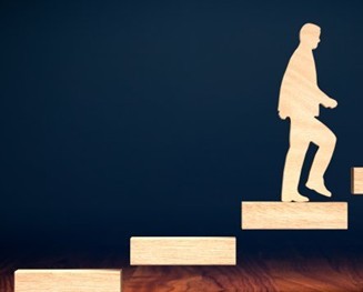 Wooden figure climbing stairs